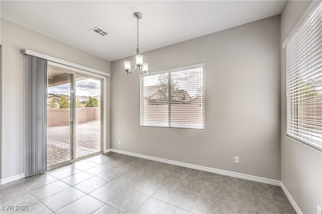 spare room featuring light tile patterned floors, visible vents, baseboards, and an inviting chandelier