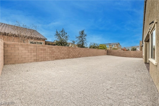 view of yard with a patio area and a fenced backyard