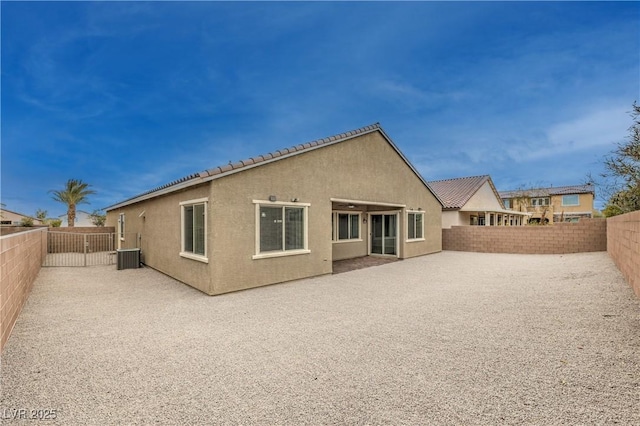 back of property featuring cooling unit, a fenced backyard, and stucco siding