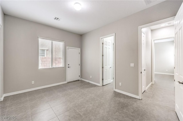 unfurnished room featuring visible vents and baseboards