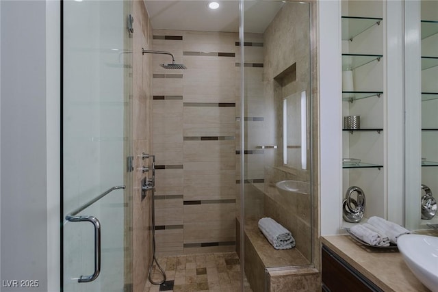 full bath with a shower stall and vanity