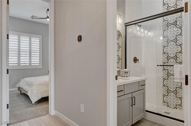 full bath with a shower stall, baseboards, and vanity