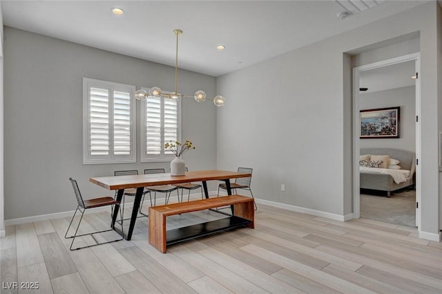 dining room with a chandelier, light wood-type flooring, baseboards, and recessed lighting