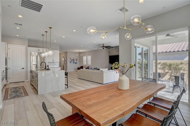 dining room featuring light wood-type flooring, visible vents, and recessed lighting