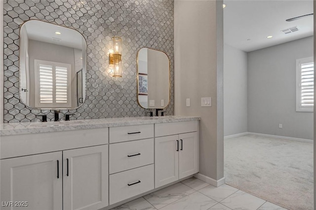 full bath featuring marble finish floor, visible vents, a sink, and baseboards