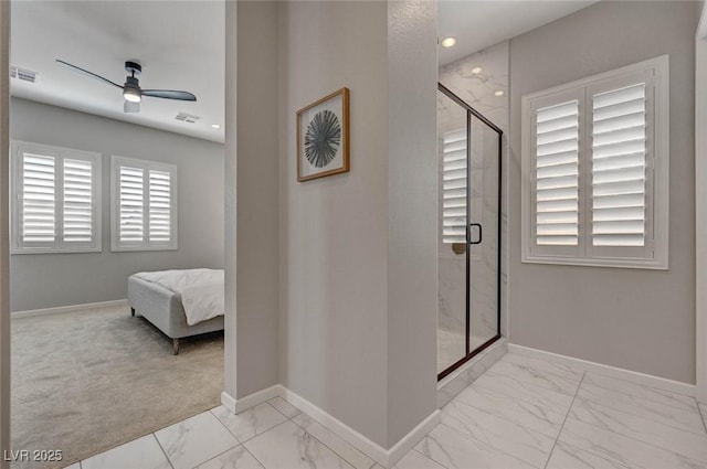 full bath with marble finish floor, a shower stall, baseboards, and ceiling fan