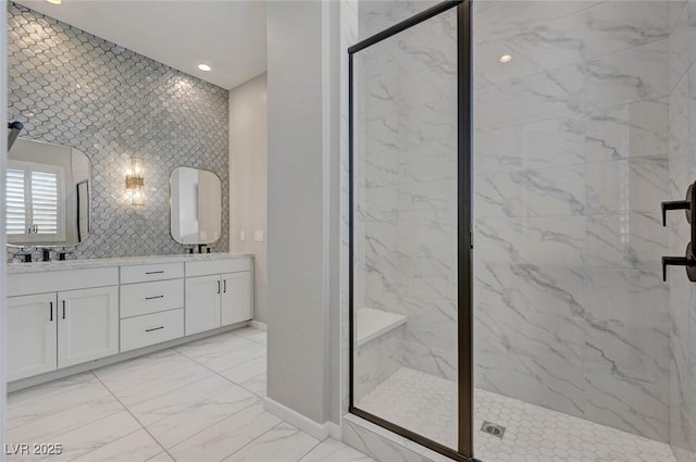 bathroom with recessed lighting, baseboards, marble finish floor, a marble finish shower, and double vanity