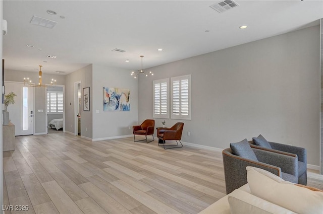 sitting room with light wood-type flooring, visible vents, a notable chandelier, and recessed lighting