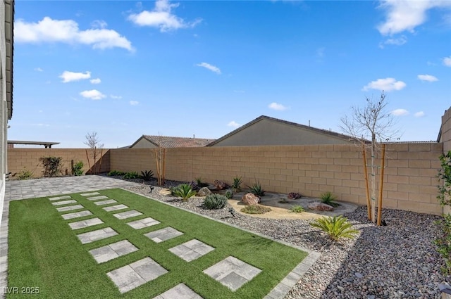 view of yard featuring a fenced backyard and a patio