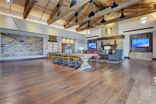 living area with high vaulted ceiling, wood ceiling, beamed ceiling, and wood-type flooring