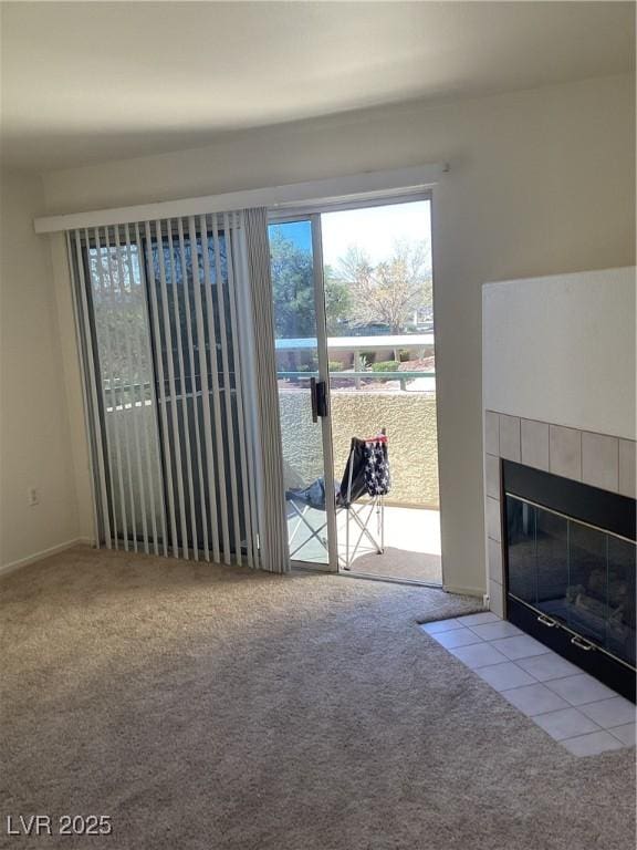 unfurnished living room with carpet and a tile fireplace