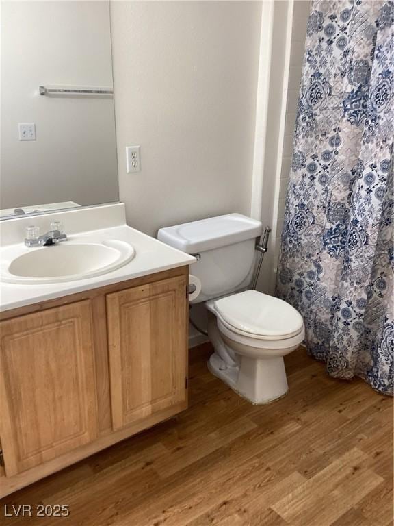 bathroom featuring a shower with curtain, vanity, toilet, and wood finished floors