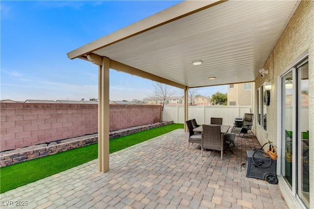 view of patio featuring outdoor dining area and a fenced backyard