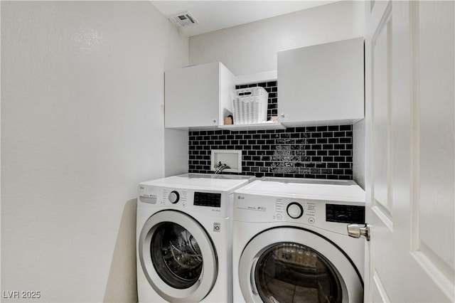 clothes washing area featuring washer and dryer, laundry area, and visible vents