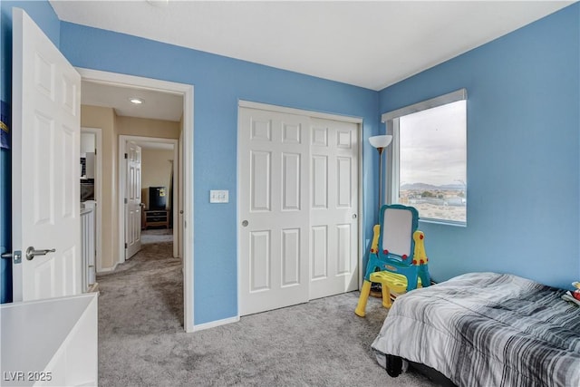 bedroom with a closet, carpet floors, and baseboards