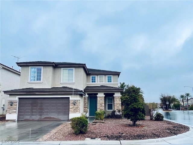 view of front facade featuring stone siding, an attached garage, concrete driveway, and stucco siding