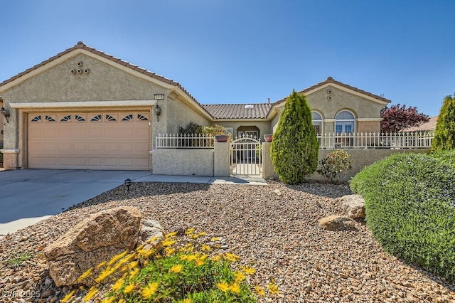 2715 Riceville Dr, Henderson, NV 89052 - mediterranean / spanish-style home with a fenced front yard, stucco siding, concrete driveway, and an attached garage