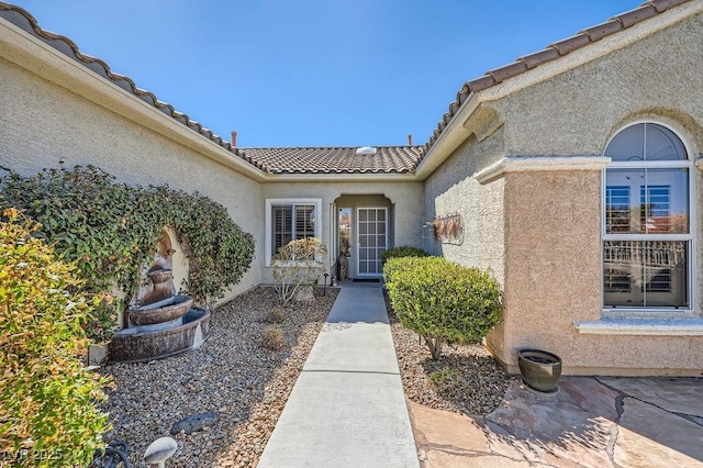 2715 Riceville Dr, Henderson, NV 89052 - doorway to property with stucco siding and a tiled roof