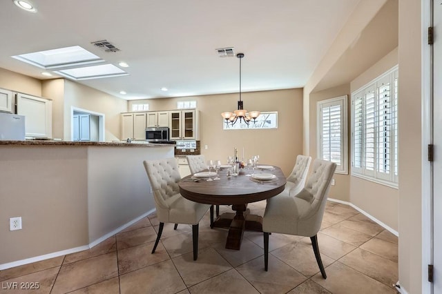 2715 Riceville Dr, Henderson, NV 89052 - dining room with a chandelier, recessed lighting, baseboards, light tile patterned flooring, and a skylight