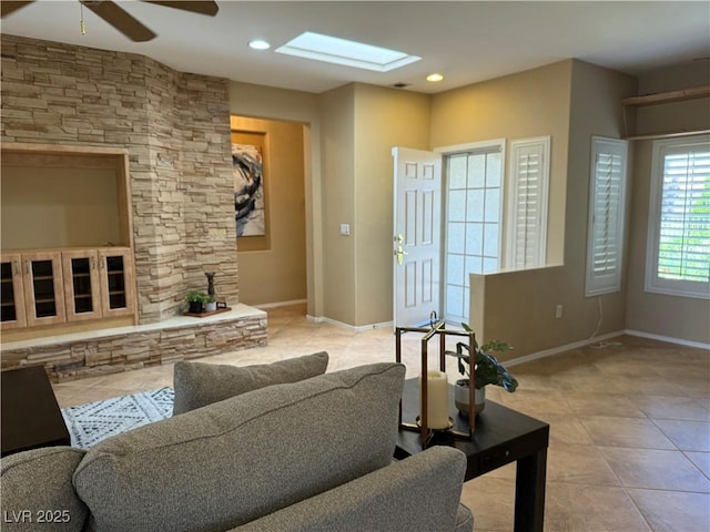 2715 Riceville Dr, Henderson, NV 89052 - living area featuring ceiling fan, baseboards, tile patterned floors, recessed lighting, and a skylight