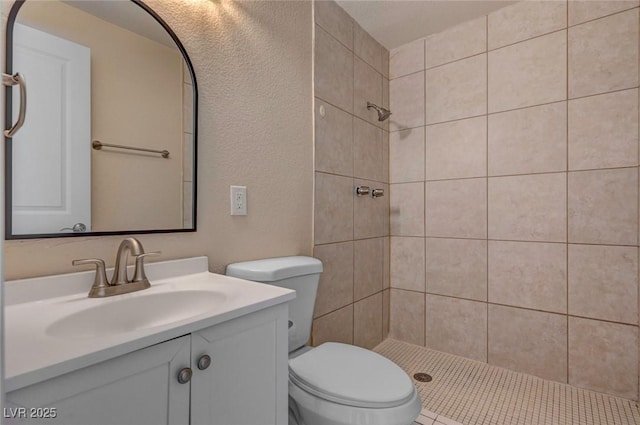 bathroom featuring a stall shower, vanity, and toilet