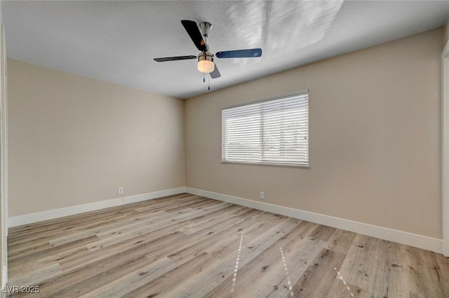 unfurnished room with a ceiling fan, a textured ceiling, baseboards, and wood finished floors