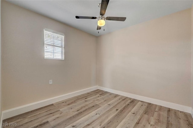 spare room featuring ceiling fan, baseboards, and wood finished floors