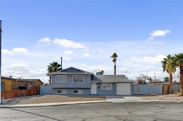 tri-level home with a gate and fence