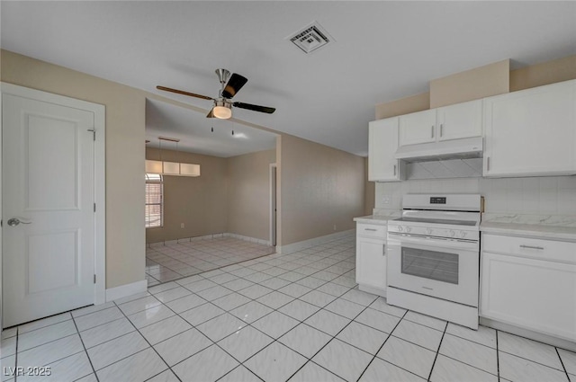 kitchen with tasteful backsplash, visible vents, white electric range, under cabinet range hood, and light tile patterned flooring