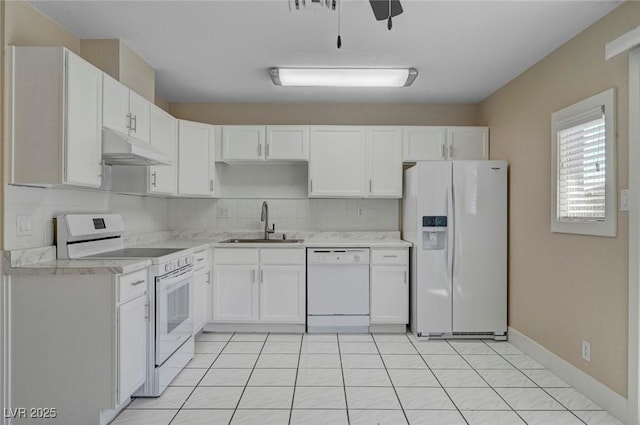 kitchen with light countertops, white cabinetry, a sink, white appliances, and under cabinet range hood