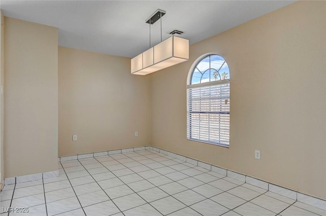 spare room with visible vents and light tile patterned flooring