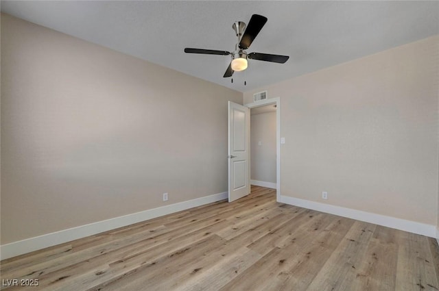 unfurnished bedroom featuring a ceiling fan, baseboards, visible vents, and light wood finished floors