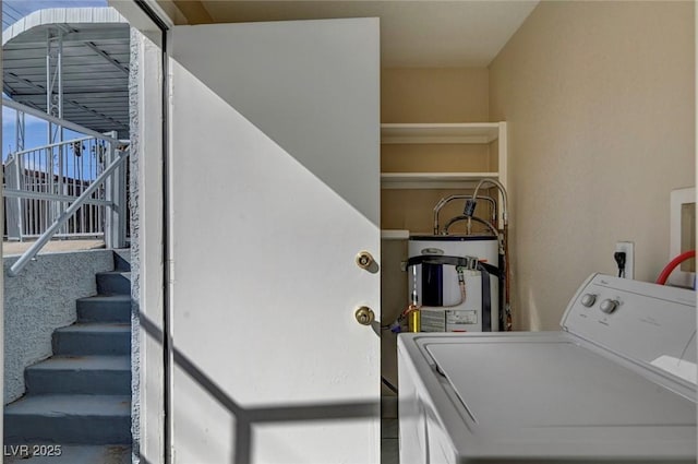 laundry room with water heater, laundry area, and washer / clothes dryer