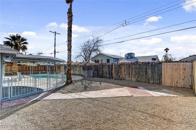 view of yard featuring a fenced in pool, a fenced backyard, and a patio