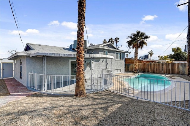 view of swimming pool with central AC unit, a patio area, fence private yard, and a fenced in pool