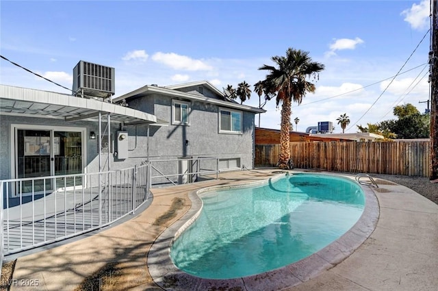 view of swimming pool featuring central AC, a patio area, a fenced backyard, and a fenced in pool