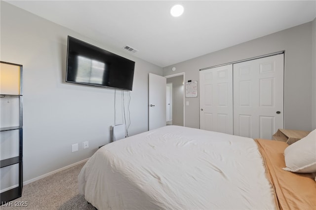 carpeted bedroom featuring a closet, visible vents, and baseboards