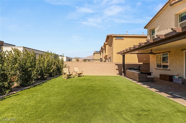 view of yard with an outdoor hangout area, ceiling fan, a patio, and a fenced backyard