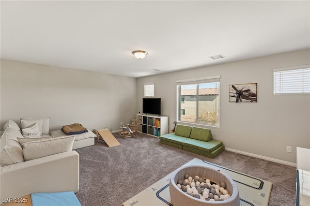 living room with carpet flooring, visible vents, and baseboards