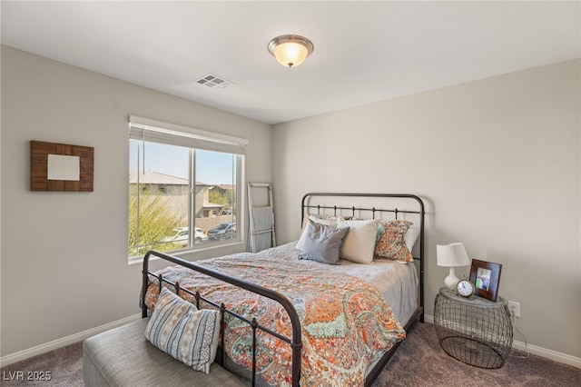 carpeted bedroom with visible vents and baseboards