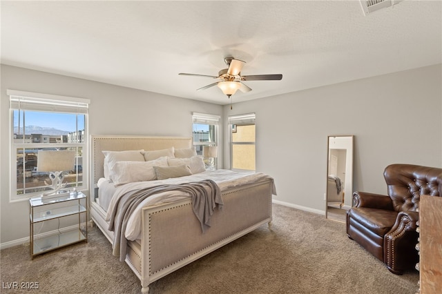 bedroom with carpet floors, multiple windows, visible vents, and baseboards