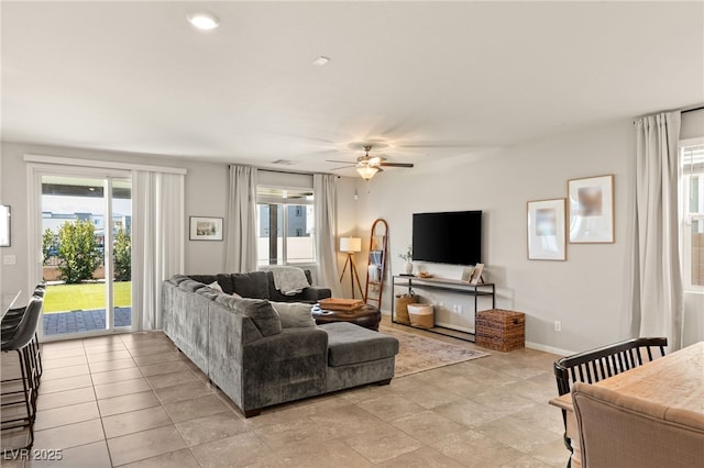 living room featuring ceiling fan and baseboards