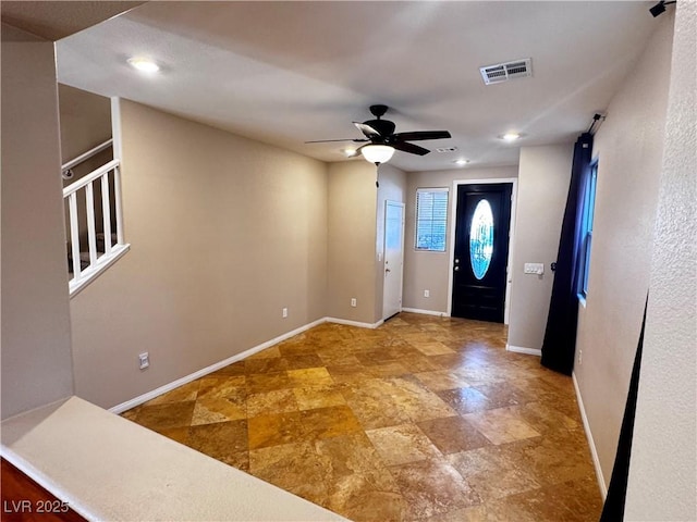 foyer entrance featuring ceiling fan, stairway, visible vents, and baseboards