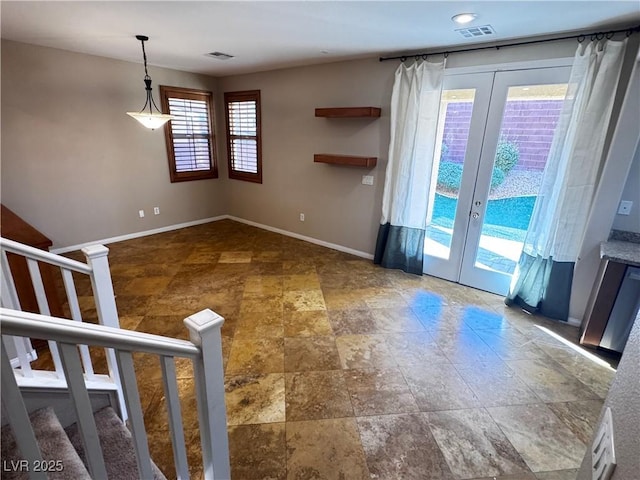 unfurnished living room featuring stairs, french doors, visible vents, and baseboards