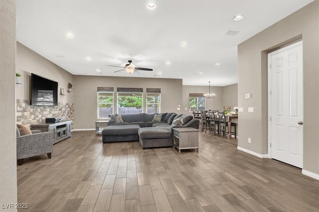 living area featuring a wealth of natural light, baseboards, and wood finished floors