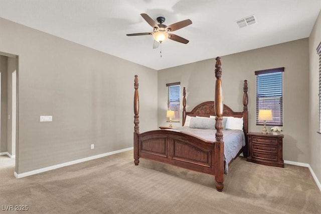 bedroom with baseboards, visible vents, a ceiling fan, and light colored carpet