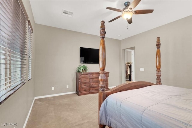 bedroom featuring light carpet, ceiling fan, visible vents, and baseboards