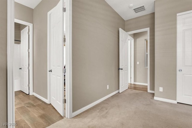 interior space with carpet, visible vents, and baseboards