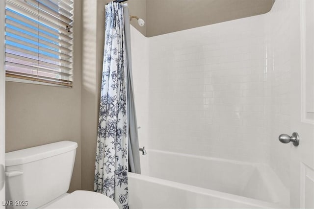 bathroom with toilet and shower / bath combo with shower curtain