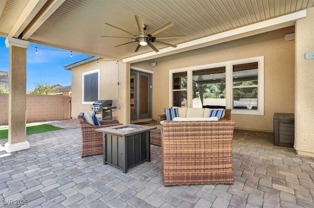 view of patio / terrace with a ceiling fan, an outdoor living space with a fire pit, fence, and area for grilling